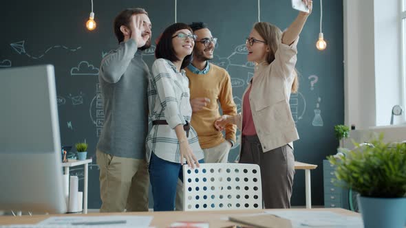 Joyful Youth Colleagues Taking Pictures with Smartphone Camera in Modern Cozy Office