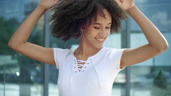 Active Young American Ethnic Woman Jumping Dancing in City Street, Outdoors. Happy Student Girl