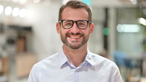 Portrait of Smiling Businessman Looking at Camera 