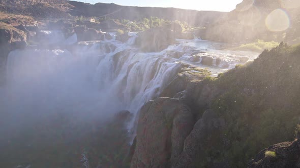 Wide panning view of Shoshone Falls as mist blows