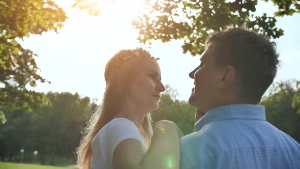 A Young Man and Woman are Hugging in a Park on a Summer Day