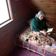 Woman in Old Age Sits on a Bed Under a Blanket with a Book in Her Hand - VideoHive Item for Sale
