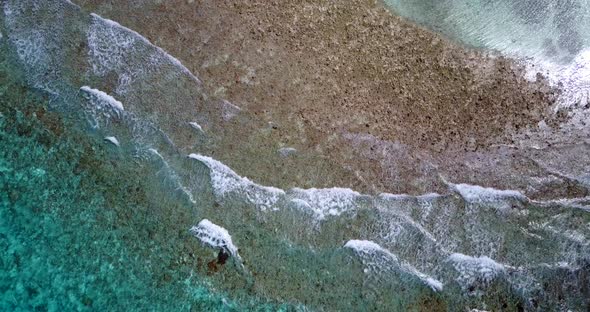 Natural aerial travel shot of a white sand paradise beach and aqua turquoise water background in hi 