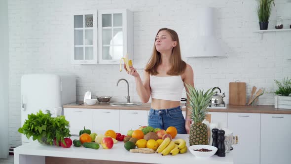 Attractive model eating banana.