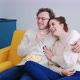 A Young Overjoyed Couple at Home Watching a Comedy Movie Laughing Loudly - VideoHive Item for Sale