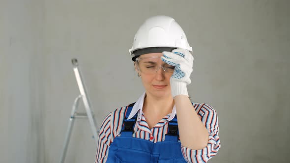 Repairwoman with a Puncher Doing Home Renovation