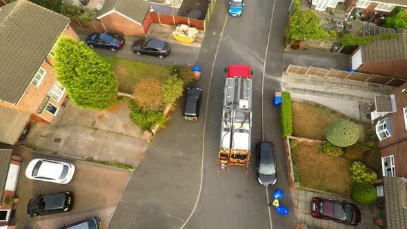 Aerial View, footage of Dustmen putting recycling waste into a garbage truck, Bin men, refuse collec