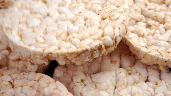 Crunchy dry rice cakes falling on a heap in slow motion. Healthy crispbread snack