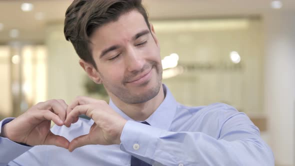 Heart Gesture By Businessman