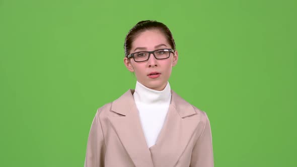 Businesswoman Corrects Glasses and Is Angry with Her Subordinates. Green Screen. Slow Motion