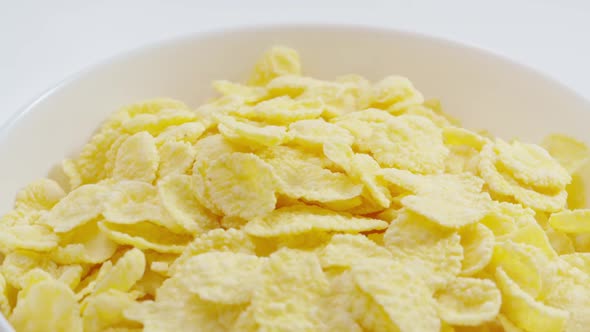 Milk Flows Into the Bowl with Cornflakes