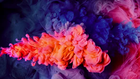 Blue Orange Colors Paint Slow Motion Ink Flow with Splash Isolated on Black