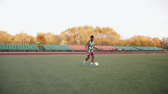 A Young Black Girl is Training on the Soccer Field and Practicing Dribbling Ball Possession on the