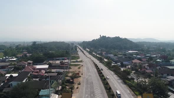 Aerial Footage of Chiang Mai-Lamphun Highway With The Massive Kru Baa Sriwichai Monk Statue Of Doi T