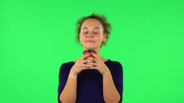 Portrait of Curly Woman Enjoying Coffee . Green Screen