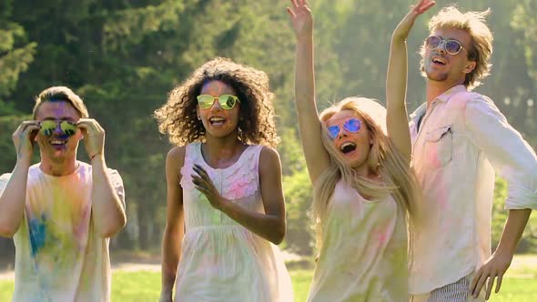 Open-Air Party, Joyful Young Friends Jumping and Dancing at Holi Festival