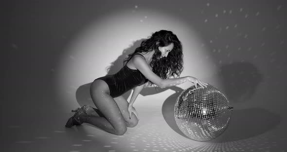 Young Woman Salsa Dancer Posing Under a Projectors Light