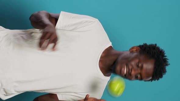 Vegetarian Man Playing with Green Apple in Studio