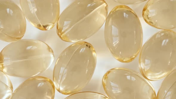 Yellow Oil Capsules Vitamin C Omega 3 Rotating Closeup