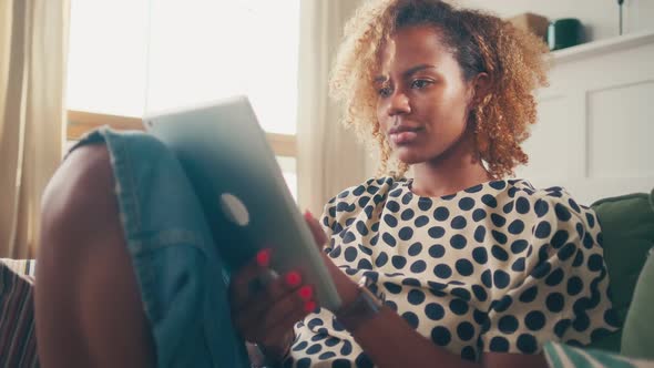 Young African American Woman Having Rest Using Tablet is Shopping in Apps