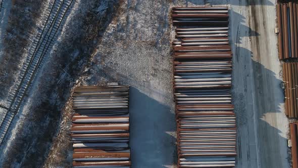 Top down aerial view of Round metal pipes in warehouse. Industrial outdoors storage site. 07