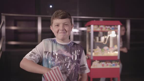 Young Boy Munching Pop Corn Happily - Ungraded