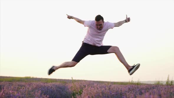 Happy Man Jumping Up in Flowering Lavender Field, Slow Motion
