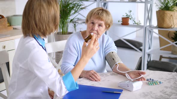Doctor Explaining Old Patient About Medications. Home Visits Or House Call
