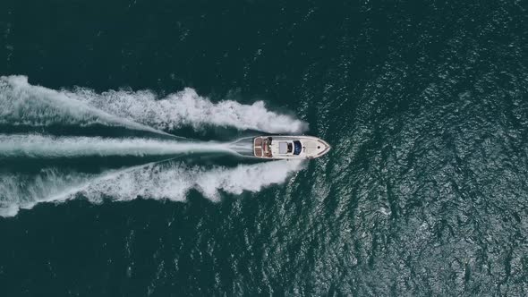 Aerial Top Down View of Speed Motor Boat on Open Sea at Summer Day