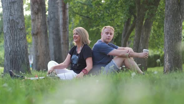 Male with Mature Mother Resting in a City Park