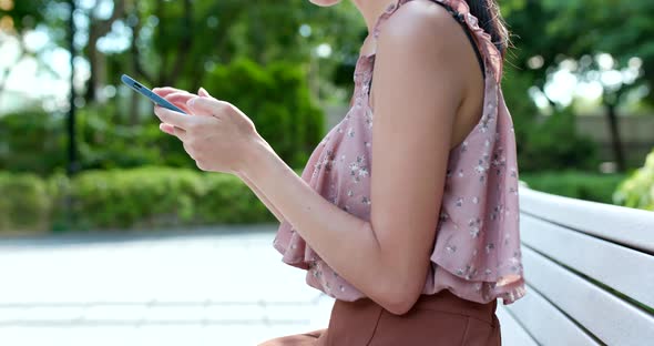 Woman use of cellphone in the park