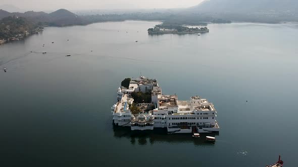 Aerial ascend over Taj lake palace in Pichola lake, Udaipur, Rajasthan, India