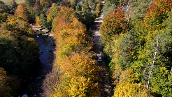 Car Travel Concept Following Car By Autumn Forest Road