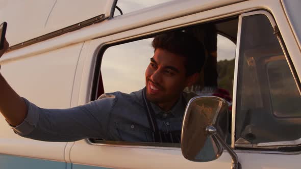 Young man taking selfies in the food truck