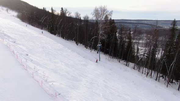 The Instructor of the Ski School Helps the Student To Climb on the Lift