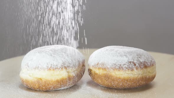 Spreading Sugar Powder On Hanukkah Doughnuts. Slow motion