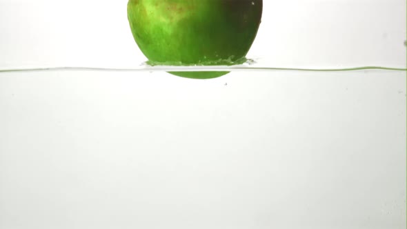 Super Slow Motion Fresh Juicy Apple Falls Into the Water with Splashes