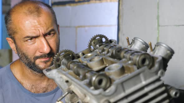 Portrait of Professional Mechanic Repairing Motor of Vehicle. Attentive Repairer Fixing Automobile