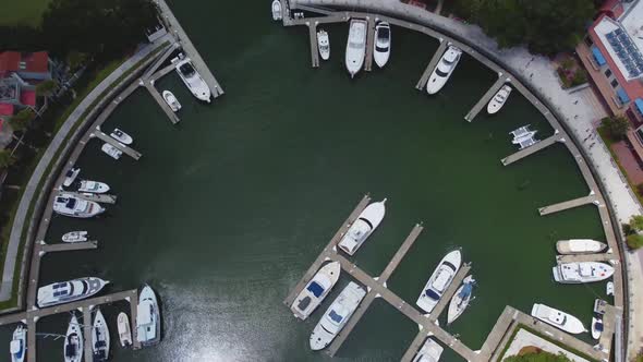 A top-down drone shot of the marina at harbor town on Hilton head island, sc. note the semi-circle s