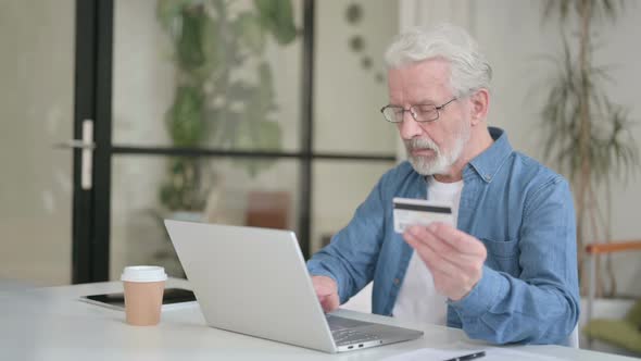 Successful Online Payment on Laptop By Senior Old Man