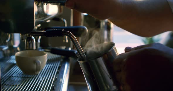 Chef filling coffee mug from machine 4k