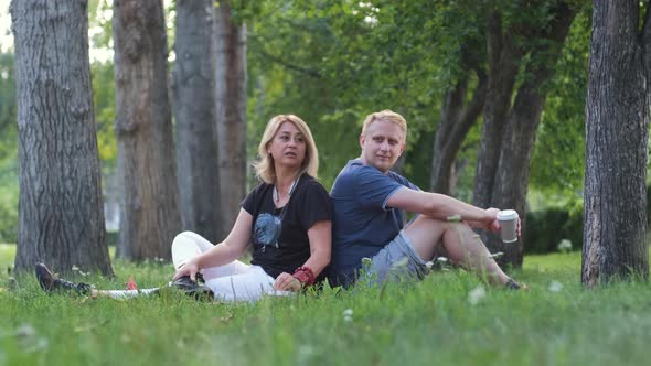 Mature Woman with Adult Son Chatting in a Park