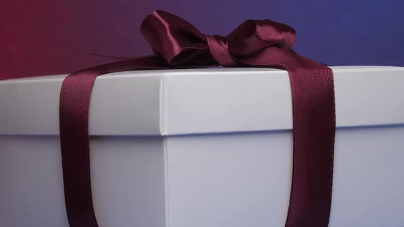 White Present Carton Box with Purple Ribbon and Bow