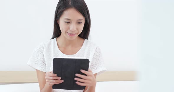 Woman use of tablet on bed