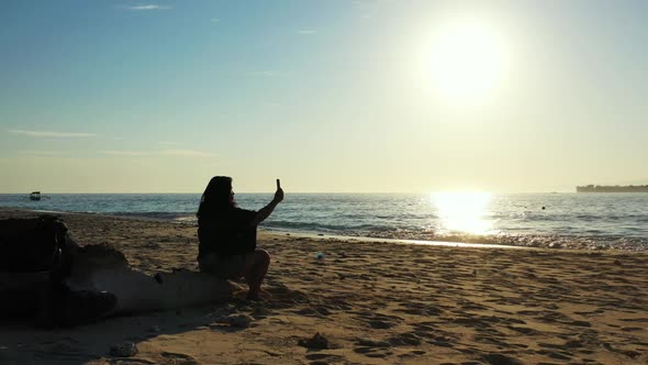 Female model happy and smiling on perfect seashore beach trip by blue lagoon with white sandy backgr