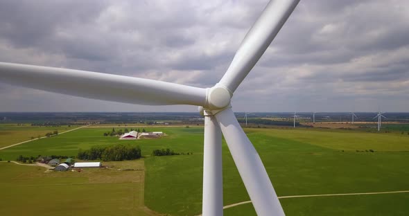 Close-up aerial of the rotating blades of a wind turbine
