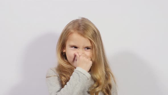 Girl Holding Her Nose Because of Bad Smell, A Girl Shows a Gesture of Bad Smell