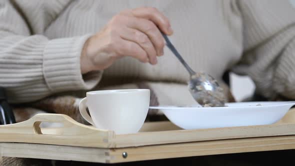 Aged Woman Eating Untasty Porridge With Disgust and Throwing Spoon, Nursing Home