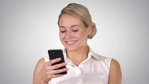 Happy Young Beautiful Woman Smiling and Using Mobile Phone