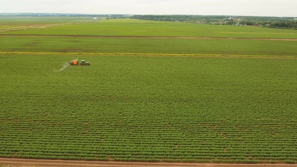 Tractor Is Spraying Fertilizers Field.